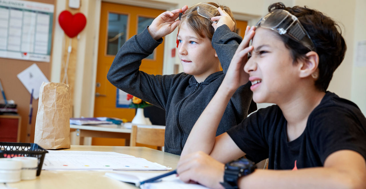 two students who look confused in the classroom